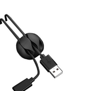 A black 10 in 1 cable organizer with a strong adhesive, designed to manage multiple cables such as data, mouse, Ethernet, and audio cables, attached to a USB cable.