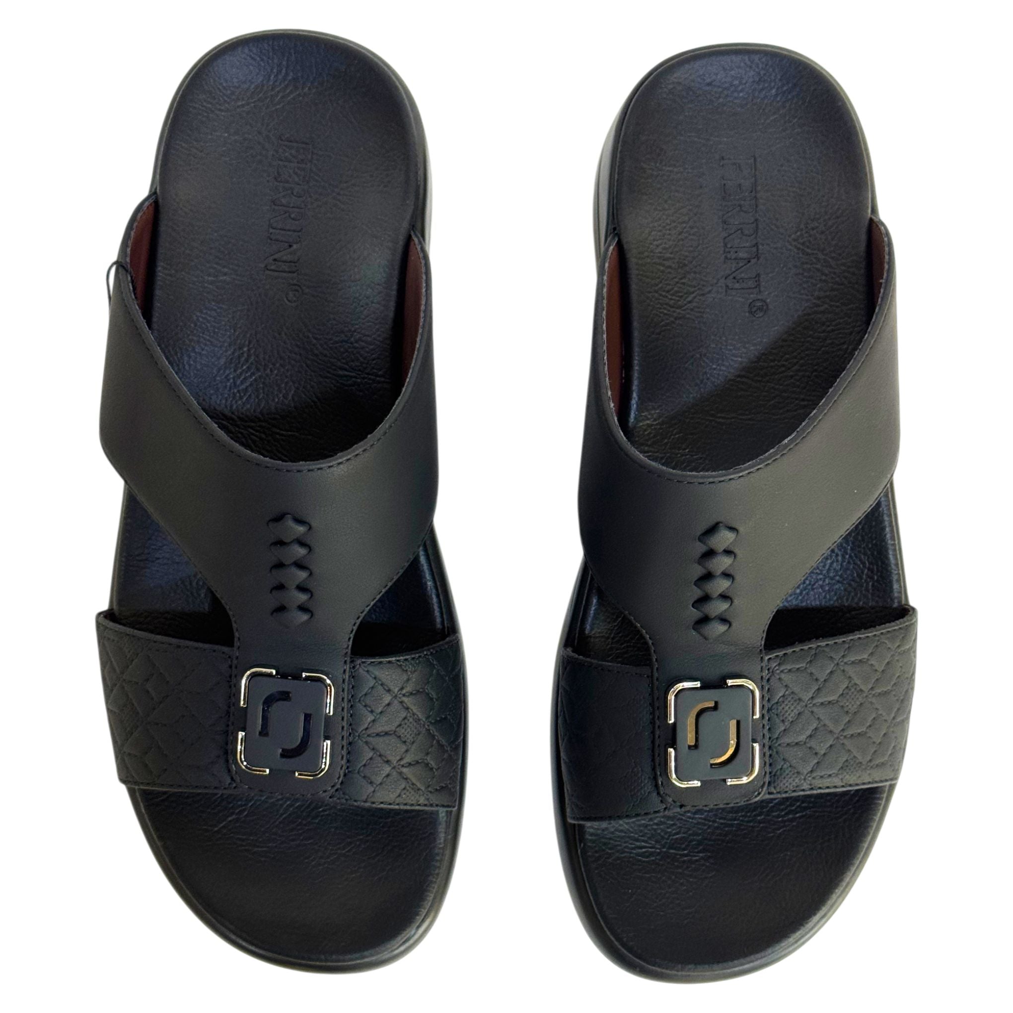 Pair of black sandals with a decorative buckle on a white background